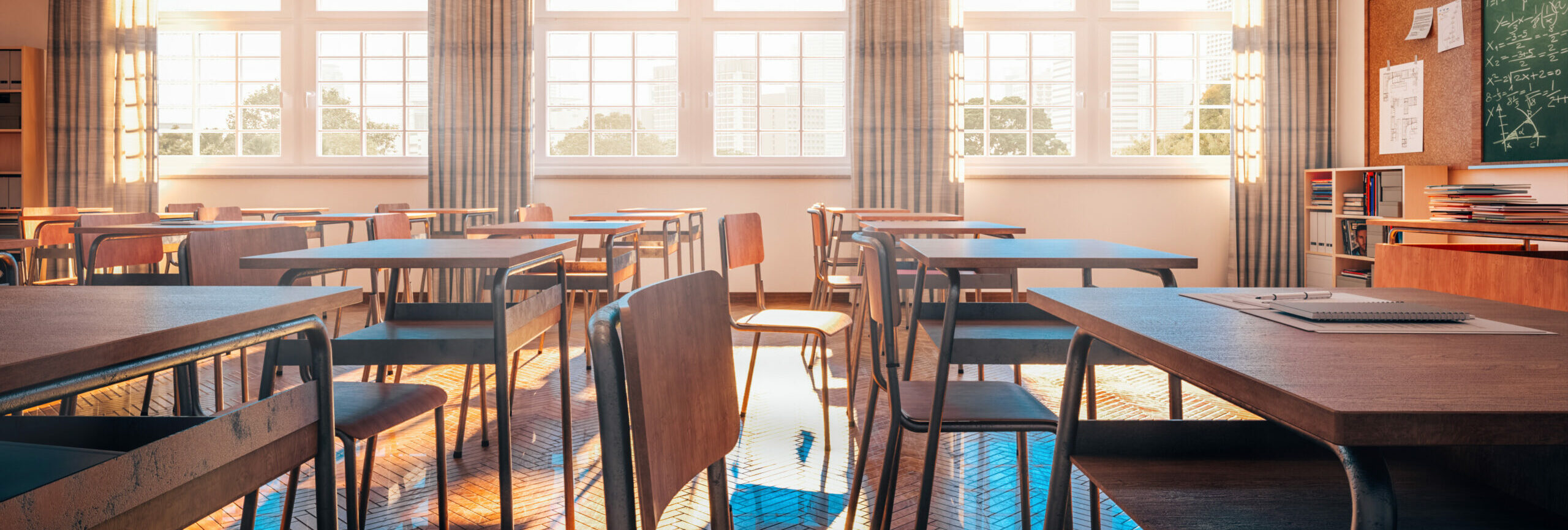 interior of a traditional school classroom with wooden floor and furniture.